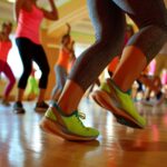 A group of people are dancing in a gym, wearing neon green shoes. Scene is energetic and fun